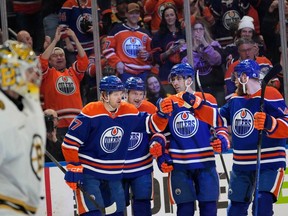 Edmonton Oilers Warren Foegele (37) celebrates his goal with teammates against the Boston Bruins goalie Jeremy Swayman (1) during first period NHL action on Wednesday, Feb. 21, 2024 in Edmonton.