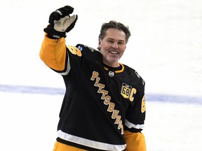 FILE - Former Pittsburgh Penguins player Jaromir Jagr stands at center ice and waves to fans after skating during warm ups after having a banner with his retired uniform number raised to the rafters of PPG Paints arena before an NHL hockey game between the Los Angeles Kings and the Penguins in Pittsburgh, Sunday, Feb. 18, 2024. Jaromir Jagr is missing. Well, the bobbleheads of the former NHL star are anyway. The Pittsburgh Penguins announced Thursday, March 14 that a shipment carrying bobbleheads of the franchise icon was stolen after arriving in California. The team had intended to give the bobbleheads away to fans during Thursday night's game against the San Jose Sharks.
