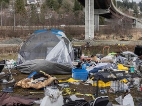 Collapsed tents and mounds of garbage mark a homeless encampment in the middle of the Cape Horn interchange in Coquitlam, March 1, 2024. The area lies between a railroad and several highway overpasses.