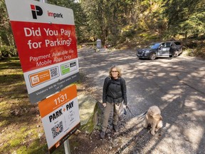 Charlotte Henriksson with her dog Cody at the Whyte Lake Trail Head in West Vancouver on March 5. Charlotte doesn't like pay parking at the trail head.
