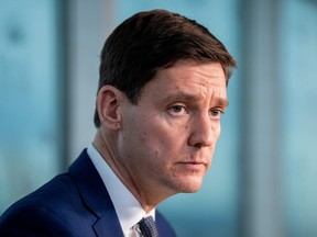 B.C. Premier David Eby listens to a question from a reporter during a news conference announcing MLA Selina Robinson will be stepping down from her position as Minister of Post Secondary Education and Future Skills in Vancouver.
