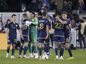 Vancouver Whitecaps players celebrate a 2-0 victory against the San Jose Earthquakes in an MLS soccer match in San Jose, Calif., Saturday, March 9, 2024.