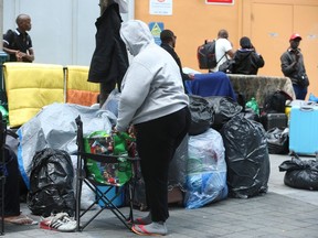 Some asylum seekers outside a city-run facility for homeless people in Toronto. Canada is now processing 140,000 asylum claimants a year, more than five times the average before Justin Trudeau was elected as prime minister.