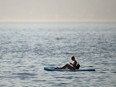A paddle boarder near Kitsilano Beach during a heatwave in Vancouver, British Columbia, Canada, on Monday, June 28, 2021.