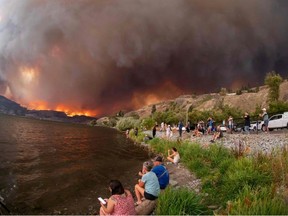 Residents watch the McDougall Creek wildfire in West Kelowna on Aug. 17, 2023.