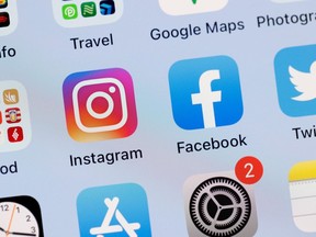 In this photo illustration, the Facebook and Instagram apps are seen on the screen of an iPhone.