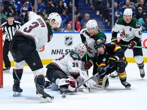 Conor Garland jams away at the puck during the first period against the Arizona Coyotes at Rogers Arena on Wednesday night.