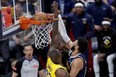Canadian Jamal Murray of the Denver Nuggets dunks on LeBron James of the Los Angeles Lakers in the fourth quarter during game five of the Western Conference First Round Playoffs at Ball Arena on April 29, 2024 in Denver, Colorado.