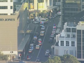 In this image made from video provided by AUBC, first responders gather near the scene of a stabbing at a shopping centre in Sydney, Australia on Saturday.