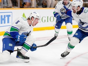 Vancouver Canucks right wing Brock Boeser (6) celebrates his game-tying hat trick goal with Conor Garland, right, late in the third period against the Nashville Predators during Game 4 of an NHL hockey Stanley Cup first-round playoff series Sunday, April 28, 2024, in Nashville, Tenn.