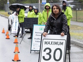 Surrey Crime Prevention Society volunteer president Mani Fallon with several society members at a speed check on 88th Avenue In Surrey.