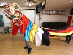 Vancouver Tsung Tsin Hakka Association members display a Chinese unicorn costume.