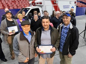 Mike Nasr (centre) with Harry Louie and son Jayson Louie inside the PNE's Agrodome. B.C. Emergency Health Services recognized the heroic actions of bystanders who helped two patients, a father and son, two years apart at the Agrodome during their cardiac emergencies.