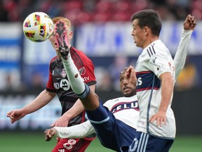 Vancouver Whitecaps' Fafa Picault, centre, gets his foot on the ball as Toronto FC's Matty Longstaff, back left, and Vancouver's Andres Cubas, front right, watch during first half MLS soccer action in Vancouver, B.C., Saturday, April 6, 2024. Last week, the Whitecaps climbed to the top of Major League Soccer's Western Conference. This week, they're fighting to stay there.THE CANADIAN PRESS/Darryl Dyck
