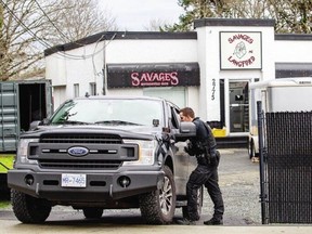 Police execute a search warrant at Savages Motorcycle Club on Spencer Road on Jan. 31. DARREN STONE, TIMES COLONIST