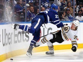 Jake McCabe of the Maple Leafs checks Jesper Boqvist of the Boston Bruins during Game 6 of the Stanley Cup playoffs at Scotiabank Arena on May 2 in Toronto.