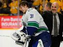 Arturs Silovs gets a pat from head coach Rick Tocchet after a shutout over the Predators in Nashville to clinch a first-round playoff series May 3.