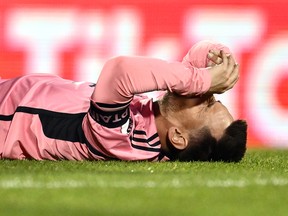 Lionel Messi grimaces in pain.