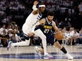 Jamal Murray, right, of the Denver Nuggets is fouled by Jaden McDaniels of the Minnesota Timberwolves during the third quarter in Game 4 of the Western Conference Second Round Playoffs at Target Center on Sunday, May 12, 2024, in Minneapolis, Minn.