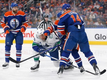 EDMONTON, ALBERTA - MAY 12: Dakota Joshua #81 of the Vancouver Canucks battles for the puck against Cody Ceci #5 and Mattias Ekholm #14 of the Edmonton Oilers during the first period in Game Three of the Second Round of the 2024 Stanley Cup Playoffs at Rogers Place on May 12, 2024 in Edmonton, Alberta.