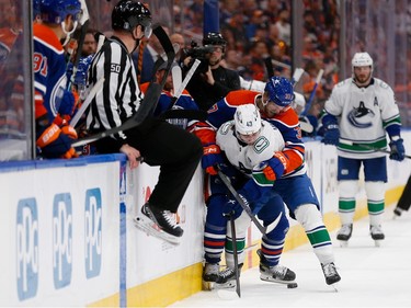 EDMONTON, ALBERTA - MAY 12: Quinn Hughes #43 of the Vancouver Canucks and Warren Foegele #37 of the Edmonton Oilers battle for the puck during the second period in Game Three of the Second Round of the 2024 Stanley Cup Playoffs at Rogers Place on May 12, 2024 in Edmonton, Alberta.