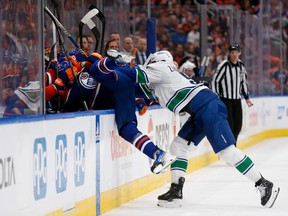 EDMONTON, ALBERTA - MAY 12: Evander Kane #91 of the Edmonton Oilers is checked by Nikita Zadorov #91 of the Vancouver Canucks during the second period in Game Three of the Second Round of the 2024 Stanley Cup Playoffs at Rogers Place on May 12, 2024 in Edmonton, Alberta.
