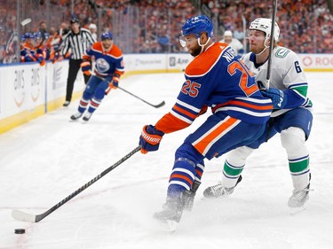 Darnell Nurse #25 of the Edmonton Oilers skates against Brock Boeser #6 of the Vancouver Canucks during the first period in Game Four of the Second Round of the 2024 Stanley Cup Playoffs at Rogers Place on May 14, 2024 in Edmonton, Alberta.