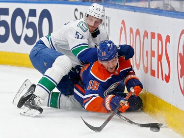 EDMONTON, ALBERTA - MAY 14: Tyler Myers #57 of the Vancouver Canucks hits Zach Hyman #18 of the Edmonton Oilers during the second period in Game Four of the Second Round of the 2024 Stanley Cup Playoffs at Rogers Place on May 14, 2024 in Edmonton, Alberta.