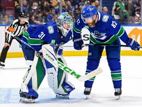 Arturs Silovs #31 and Ian Cole #82 of the Vancouver Canucks speak during the second period in Game Seven of the Second Round of the 2024 Stanley Cup Playoffs at Rogers Arena on May 20, 2024 in Vancouver, British Columbia.