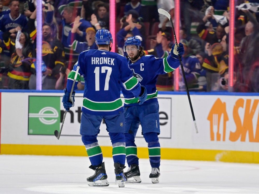 Filip Hronek #17 and Quinn Hughes #43 of the Vancouver Canucks celebrate after a goal during the third period in Game Seven of the Second Round of the 2024 Stanley Cup Playoffs at Rogers Arena on May 20, 2024 in Vancouver, British Columbia.