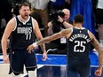 Luka Doncic (77) and P.J. Washington (25) of the Dallas Mavericks celebrate during the final minute of the fourth quarter against the Minnesota Timberwolves in Game 3 of the Western Conference Finals at American Airlines Center on Sunday, May 26, 2024, in Dallas, Texas.