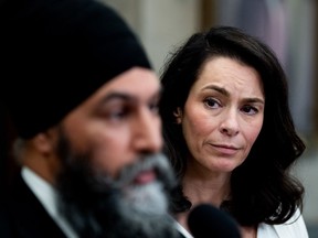 Heather McPherson, looks on as NDP Leader Jagmeet Singh speaks to reporters in the Foyer of the House of Commons on Parliament Hill in Ottawa, on Monday, March 18, 2024. THE CANADIAN PRESS/Spencer Colby