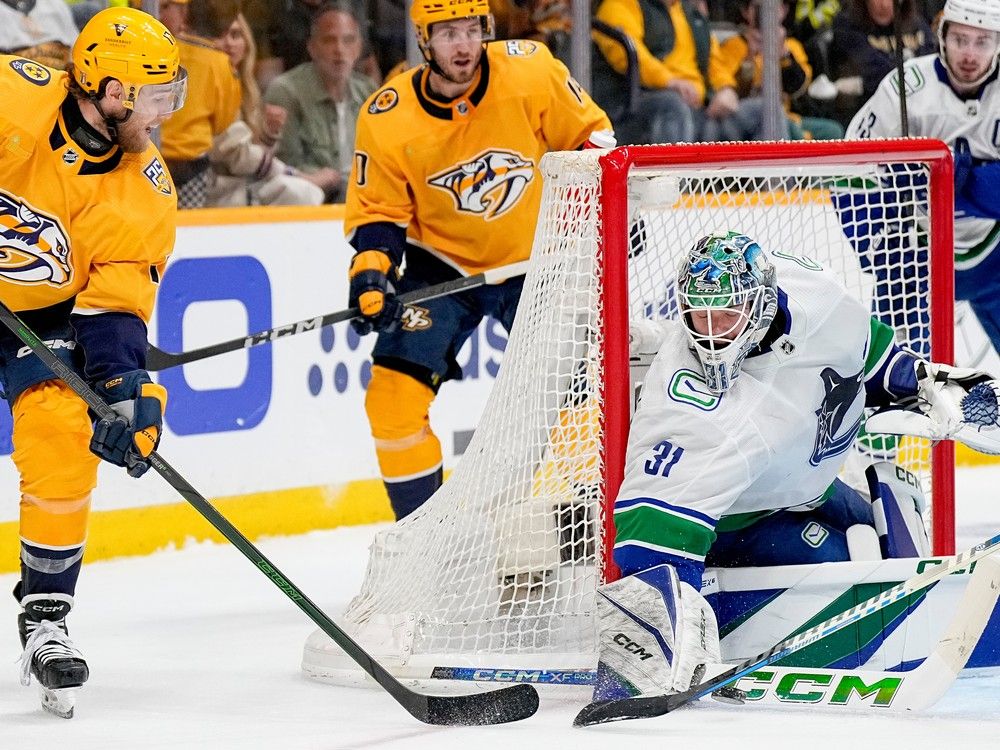 Vancouver Canucks goaltender Arturs Silovs  blocks a shot on goal by Nashville Predators centre Mark Jankowski, left, during the second period in Game 6 of Stanley Cup first-round playoff series  May 3, 2024, in Nashville. 