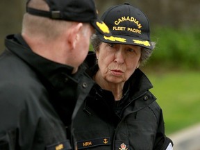 Princess Anne speaks with a naval officer as she arrives for a tour of the God's Acre cemetery at Esquimalt, B.C., on Saturday, May 4, 2024.