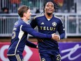 Vancouver Whitecaps FC forward Levonte Johnson (right) celebrates his goal with teammate midfielder Ryan Gauld during second half soccer action against the Cavalry FC in the Canadian Championship quarter-final, leg 1, in Calgary, Tuesday, May 7, 2024.