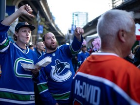 Canucks fans boo a person wearing a Connor McDavid jersey before the Edmonton Oilers and the Vancouver Canucks play Game 1 of an NHL hockey Stanley Cup second-round playoff series, in Vancouver, on Wednesday, May 8, 2024.