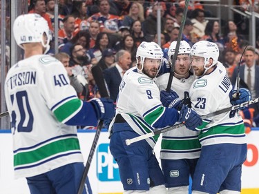 Vancouver Canucks' Elias Pettersson (40), J.T. Miller (9), Brock Boeser (6) and Elias Lindholm (23) celebrate a goal against the Edmonton Oilers during first period NHL playoff action in Edmonton on Sunday May 12, 2024.