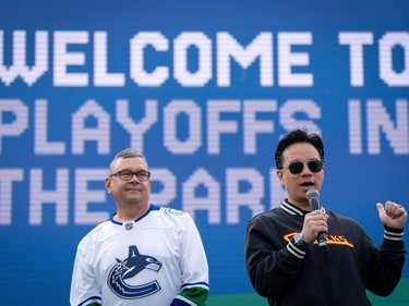Vancouver Mayor Ken Sim, right speaks at a Vancouver Canucks "Playoffs in the Park" viewing party with Councillor Mike Klassen, left, in Vancouver, B.C., Sunday, May. 12, 2024.