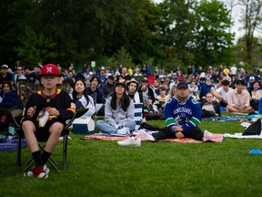 People watch the Vancouver Canucks play the Edmonton Oilers at a