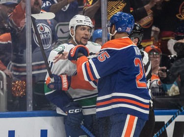 Vancouver Canucks' Dakota Joshua (81) and Edmonton Oilers' Darnell Nurse (25) rough it up during first period second-round NHL playoff action in Edmonton on Tuesday May 14, 2024.THE CANADIAN PRESS/Jason Franson