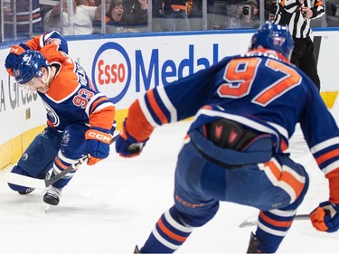 Edmonton Oilers' Ryan Nugent-Hopkins (93) and Connor McDavid (97) celebrate a goal against the Vancouver Canucks during second period second-round NHL playoff action in Edmonton on Tuesday May 14, 2024.THE CANADIAN PRESS/Jason Franson