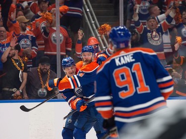 Ryan McLeod (71) and Mattias Ekholm (14) of the Edmonton Oilers, celebrate their first period goal against  the Vancouver Canucks at Rogers Place in Edmonton on May 12, 2024.  Photos by Shaughn Butts-Postmedia
