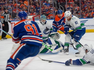 Evander Kane (91) of the Edmonton Oilers, has his shot blocked by Connor Garland (8) of the Vancouver Canucks at Rogers Place in Edmonton on May 12, 2024.  Photos by Shaughn Butts-Postmedia