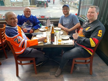 VANCOUVER, May 14, 2024 -- Sudhir Padmanabhan (left) brought his friends along -- Jay Pattel, Jared Cummings and Matt Straw -- to watch Game 4 of the Oilers-Canucks playoffs series at Gastown's Black Frog Eatery. PHOTO BY GORD MCINTYRE