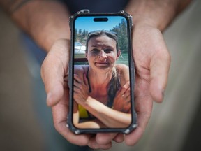 Jason Gaudreault, whose partner Tatjana Stefanski was found dead on April 14 after disappearing a day earlier, shows a photograph of her on his phone, in Lumby, on Monday, May 13, 2024. RCMP say Stefanski, 44, was last seen on April 13 with her ex-husband before "departing unexpectedly" with him in a black Audi.