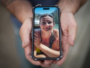 Jason Gaudreault, whose partner Tatjana Stefanski was found dead on April 14 after disappearing a day earlier, shows a photograph of her on his phone, in Lumby, B.C., on Monday, May 13, 2024.