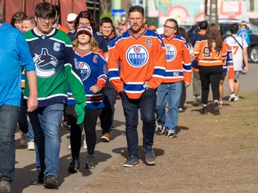 Oilers and Canucks fans walk to the arena before the start of the Vancouver Canucks, Edmonton Oilers second-round NHL playoff game in Edmonton on Tuesday, May 14, 2024 in Edmonton. Greg Southam-Postmedia