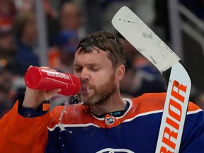 Edmonton Oilers' goalie Calvin Pickard (30) takes a drink before second period play begins against the Vancouver Canucks' during second-round NHL playoff action in Edmonton on Tuesday, May 14, 2024 in Edmonton.