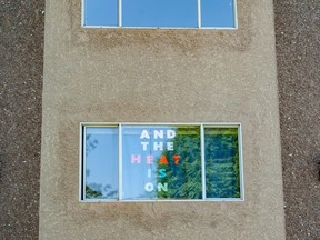 A sign warning of the inevitable heat in the window of an apartment in Vancouver.