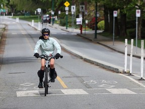 A cyclist rides in a protected bike lane in Vancouver on May 6, 2024.